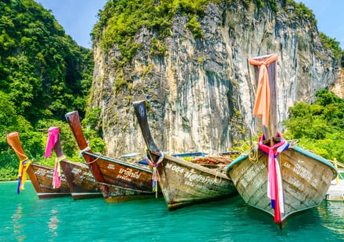 Krabi, Thailand, November 7, 2017: Traditional Thai motor boats on an island in the Andaman Sea in Krabi, Thailand