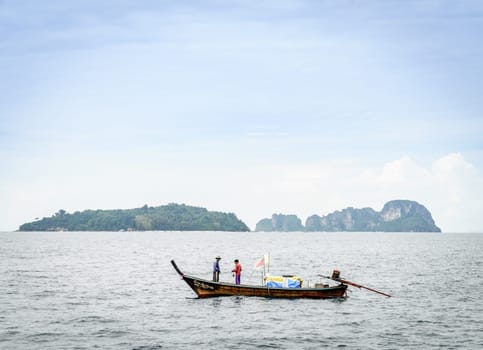 Krabi, Thailand, November 9, 2017: Thai long tail fishing boat in the Andaman Sea with islands on the horizon