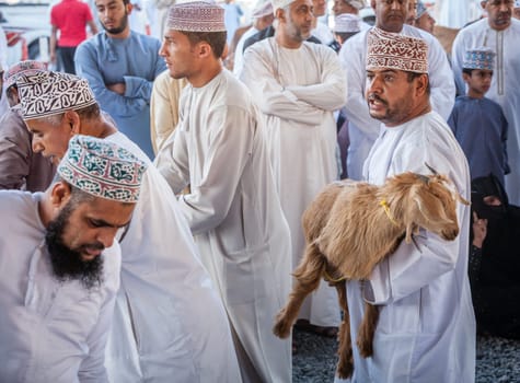 Nizwa, Oman, December 2, 2016: Goat sellers at the Friday goat market in Nizwa, Oman