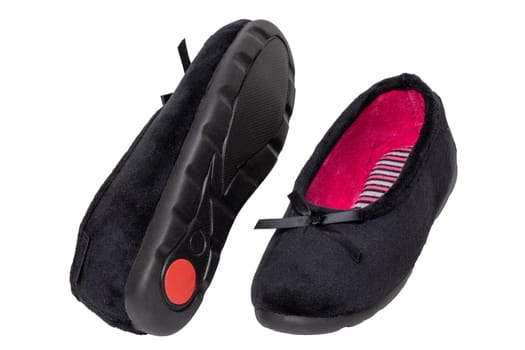 Slippers isolated. Close-up of a pair of black female house slippers or ballerina shoes isolated on a white background. Macro of woman shoes.
