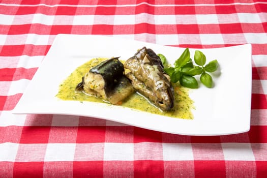 Freshly caught eel from the Havel river in Potsdam (Germany) was cooked in a broth of vegetables, greens, spices and white wine and served on a porcelain plate with a dill sauce. Healthy food.