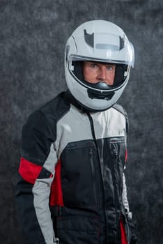 a portrait of senior biker with white helmet