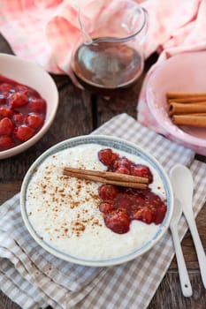 Bowl of rice pudding with cherries and cinnamon