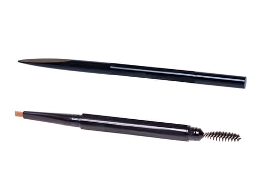 Cosmetic tools. Macro photograph of a slanted professional eyebrow pencil and brush isolated on a white background.