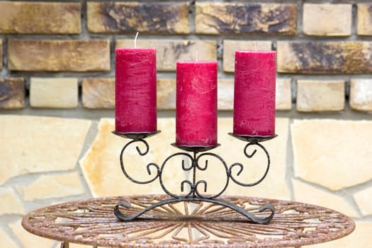 Retro candlestick with candles on old metal table