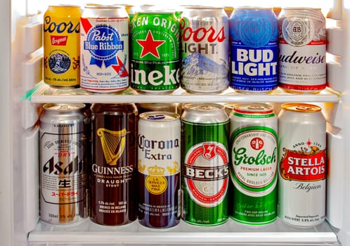 Calgary, Alberta, Canada. Jun 9 2020. Various beer cans of craft beers, domestic and imported beers from around the world on a mini fridge in a house cooler.Alcohol drinks background, different beer styles.