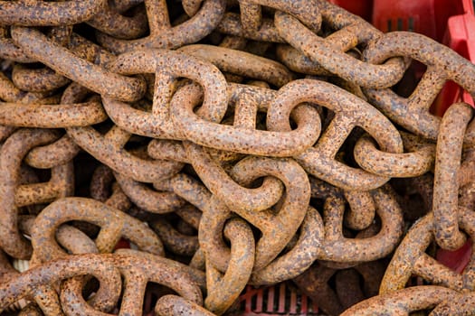 Old ship chain rusting in port