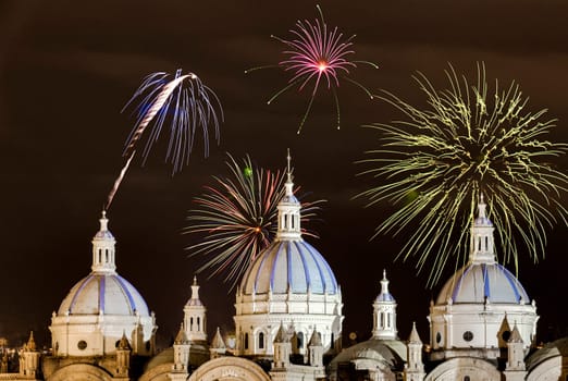 Fireworks over the domes of the New Cathedral in Cuenca, Ecuador. These are the famous view that are usually found on all travel brochures for the city.