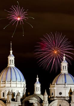 Fireworks over the domes of the New Cathedral in Cuenca, Ecuador. These are the famous view that are usually found on all travel brochures for the city.