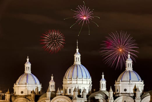 Fireworks over the domes of the New Cathedral in Cuenca, Ecuador. These are the famous view that are usually found on all travel brochures for the city.