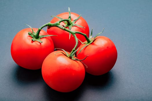 Four tomatoes on the vine