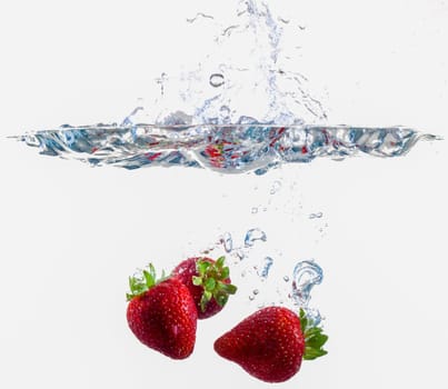 Ripe Strawberries Dropping Into Water