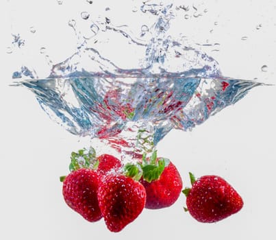 Ripe Strawberries Dropping Into Water