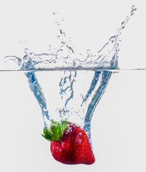 Ripe Strawberries Dropping Into Water