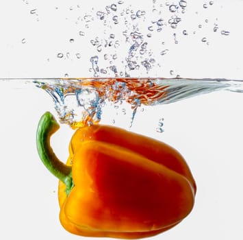 Orange Bell Pepper Dropping Into Water