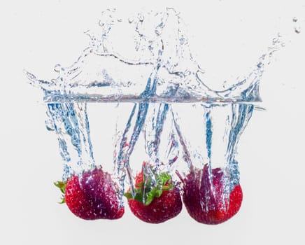 Ripe Strawberries Dropping Into Water