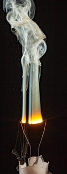 An electrical element in a light bulb igniting and burning out