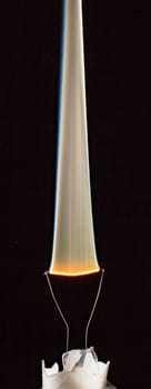 An electrical element in a light bulb igniting and burning out