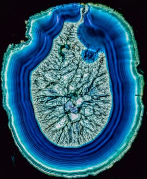 Concept of a volcano breaking through the surface  slice of blue agate through polarized light
