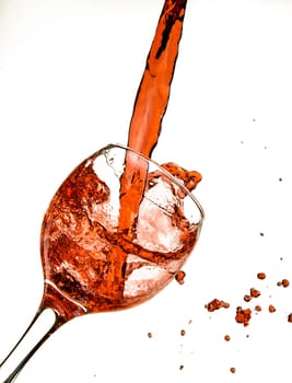 Wine being poured into glass, with slop spilling over.