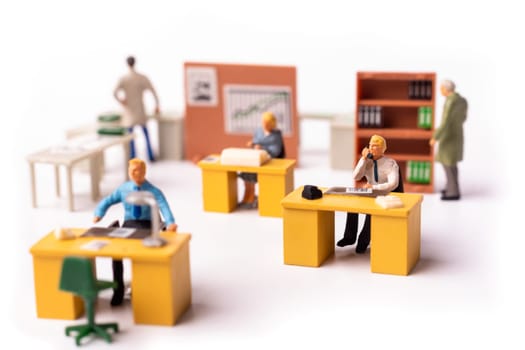 Miniature businesspeople team at the office. Macro shot of Tiny people business concept. Shallow Dept Of Field