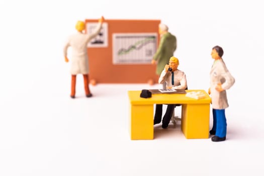 Miniature businesspeople team at the office. Macro shot of Tiny people business concept. Shallow Dept Of Field