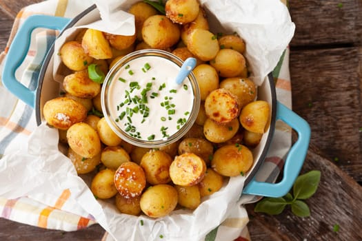 Baked potaoes with with a jar of sour cream