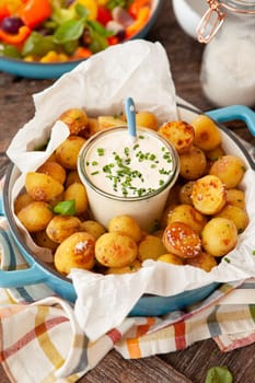 Baked potaoes with with a jar of sour cream