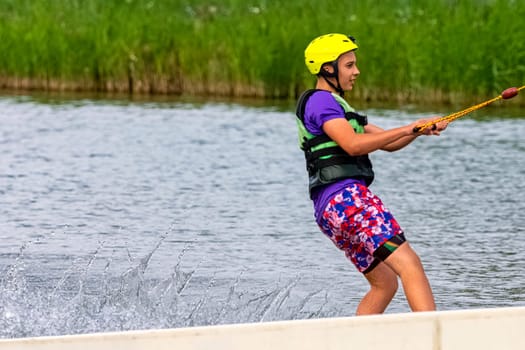 Teenager wakeboarding on a lake - Brwinow, Masovia, Poland