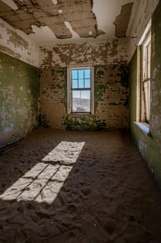 Sand has invaded and taken over these rooms in Kolmanskoppe, Namibia