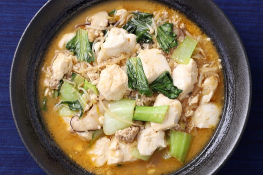 Chinese cuisine mapo tofu in a dish on wooden tray, Japanese style,