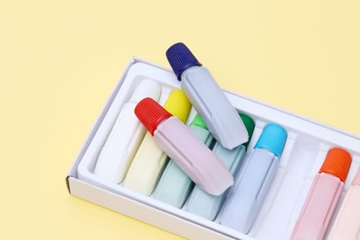 Tube of water color paint on yellow paper background