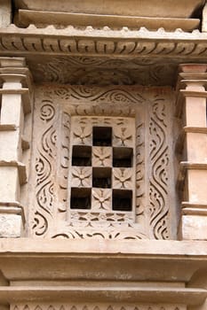Floral design and square holes of stone window frame at Jain Temple in Khajuraho, Madhya Pradesh, India, Asia