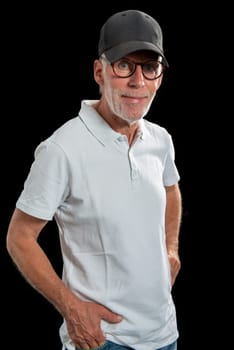 a sixty year old man wearing a baseball cap on black background