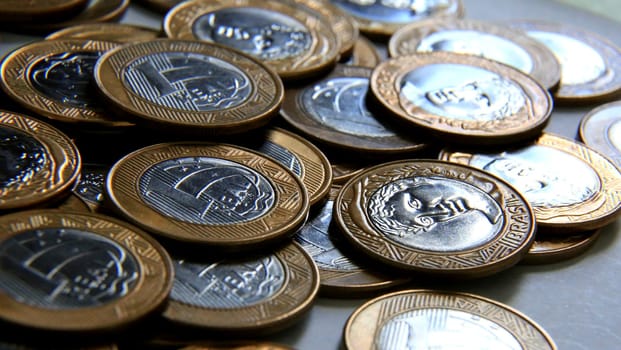 salvador, bahia / brazil - january 23, 2015: Heaped real coins forming collection in the city of Salvador...
