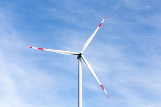 The windmill with a blue sky in the background