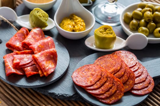 Assortment of tapas and antipasti on black background. Charcuterie boards of assorted appetizers.