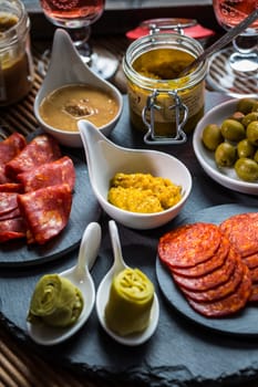 Assortment of tapas and antipasti on black background. Charcuterie boards of assorted appetizers.