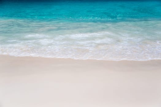 The beach with white sand and turquoise water with waves