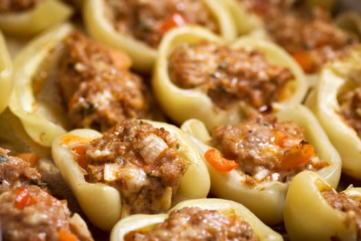 Close-up photo of baked filled peppers with meat and vegetables.
