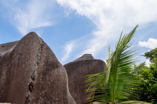 Blue sky with some clouds and big stones in front
