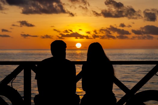 Sunset on the Maldives, a couple on the beach looking in the distance