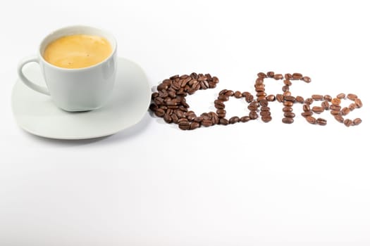 A White cup with coffee on a white background and coffee beans