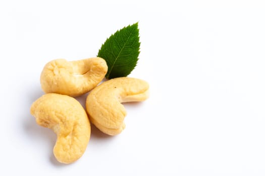 A Cashew nuts with a green leaf on white background