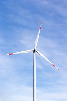 The windmill with a blue sky in the background
