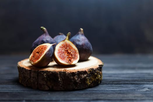 sliced fig fruits on a wooden board.