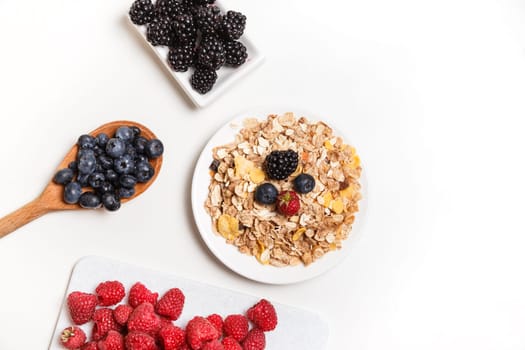 bowl of corn flakes and jug of milk on white background