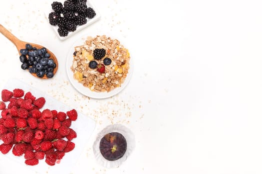 Healthy breakfast super food cereal concept with fresh fruits isolated on white. Top view.