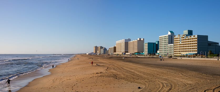 Virginia Beach, city in the state of Virginia, at the Atlantic coast, United States of America, during clear sky, and surfers enjoying the waves