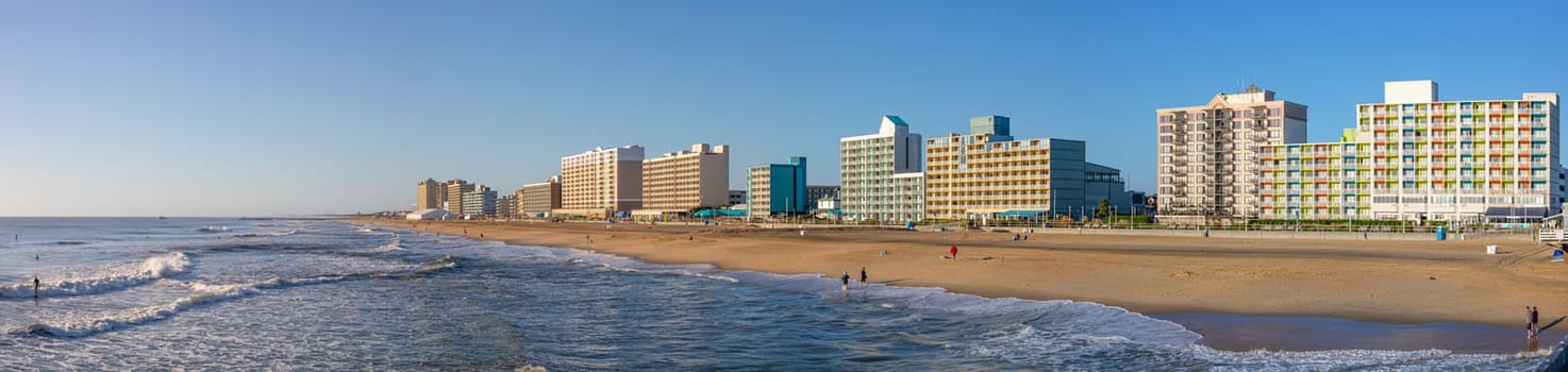 Virginia Beach, city in the state of Virginia, at the Atlantic coast, United States of America, during clear sky, and surfers enjoying the waves